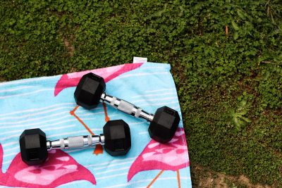 dumbbells on a beach towel on grass