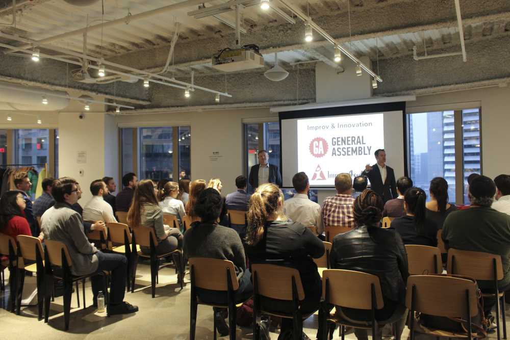 The audience looks on during “Improv and Innovation” on Wednesday evening. The event aimed to educate people about how improv can help communication in a work setting. PHOTO BY HANNAH ROGERS/DAILY FREE PRESS STAFF 

