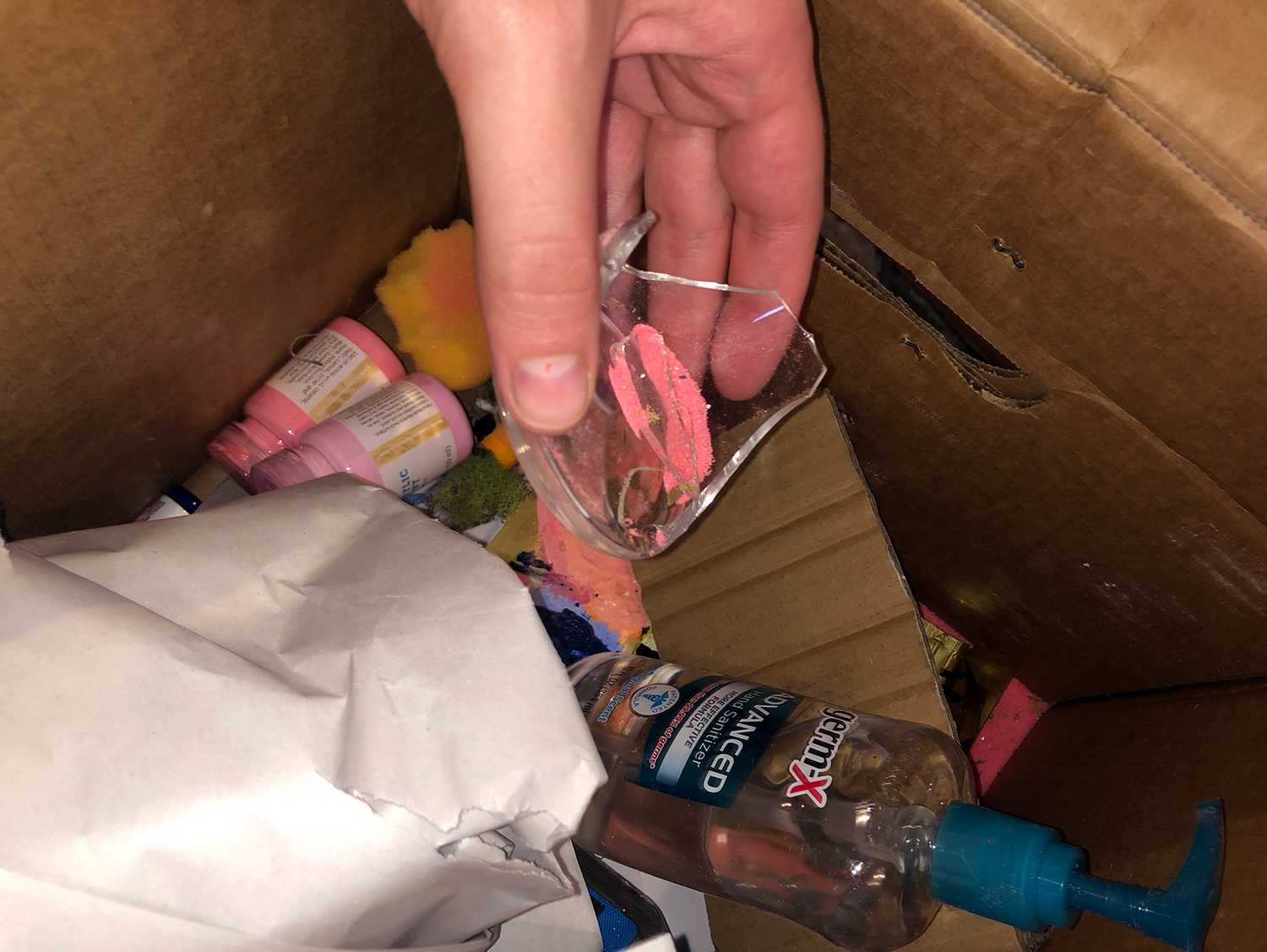 Boston University student Kait McFall holds a broken glass jar from a box of her belongings that was packed and shipped to her home by the University. COURTESY OF KAIT MCFALL