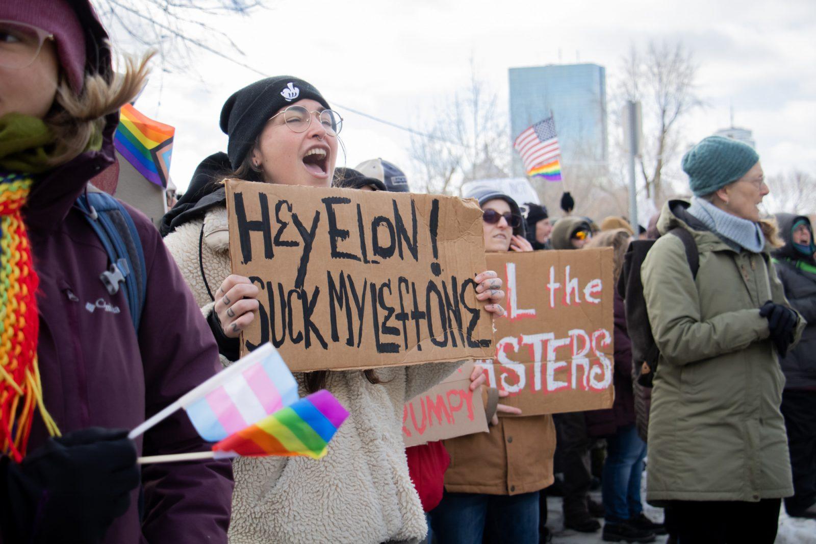 Protestors hold signs and wave flags at “No Kings on Presidents’ Day” protest Monday. Hundreds of protestors gathered at the Massachusetts State House to oppose recent executive orders and policy changes by the Trump administration, condemning alleged government overreach, attacks on human rights and the erosion of democratic norms. TALIA LISSAUER/DFP PHOTOGRAPHER 