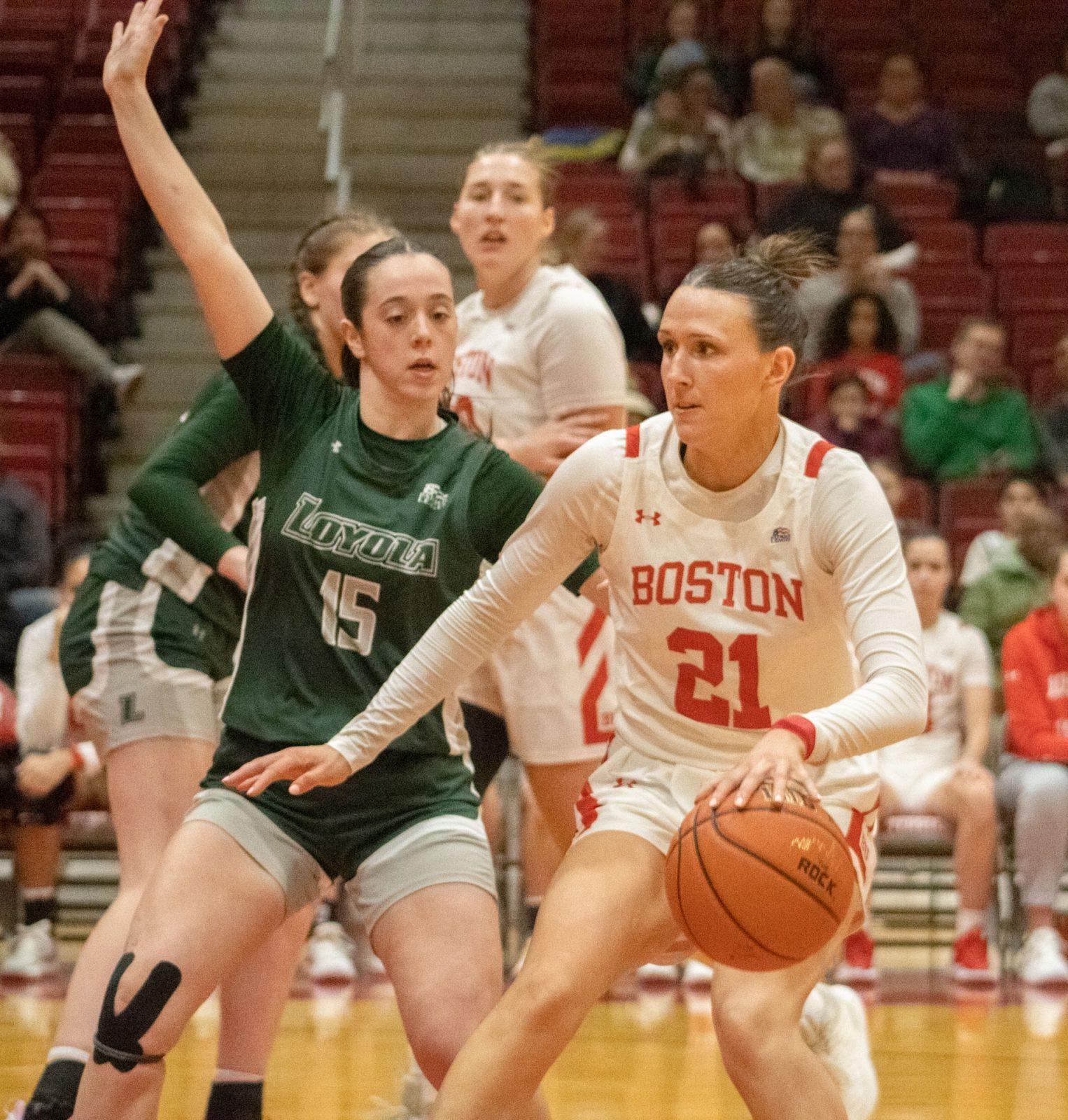 Sophomore guard Audrey Ericksen (21) dribbles the ball away from an opposing player in a game against Loyola Maryland Feb. 1. The Boston University women’s basketball team fell 44-62 to Lehigh University in the PL Quarterfinals Monday. TALIA LISSAUER/DFP PHOTOGRAPHER 