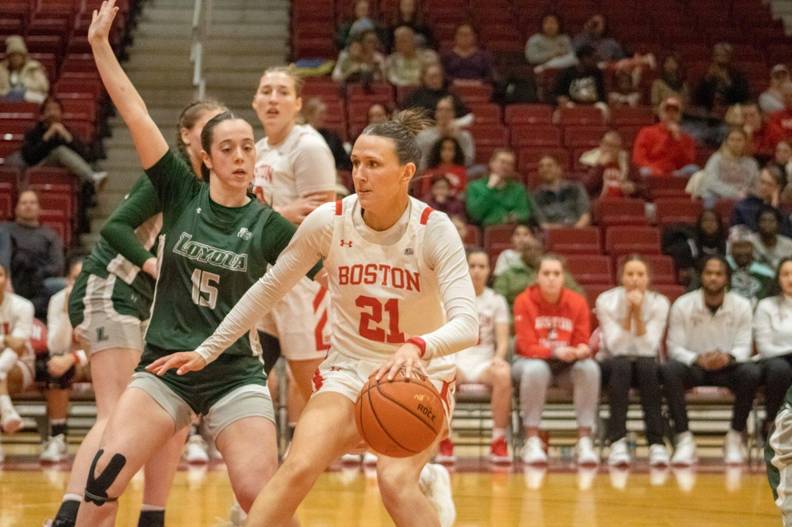 Sophomore guard Audrey Ericksen (21) dribbles the ball during a game against Loyola Maryland on Feb. 1. The Boston University women’s basketball team lost to Holy Cross at the Hart Center Arena on Saturday. TALIA LISSAUER/DFP PHOTOGRAPHER 
