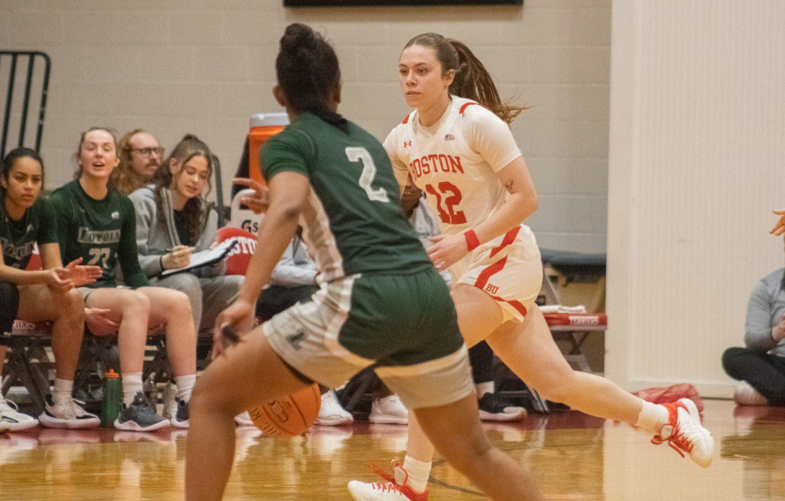 Sophomore guard Bella McLaughlin (12) dribbles the ball during a home game against Loyola on Feb. 1. Boston University’s women’s basketball team won 55-38 against Loyola on Wednesday, ending a four-game losing streak. TALIA LISSAUER/DFP PHOTOGRAPHER