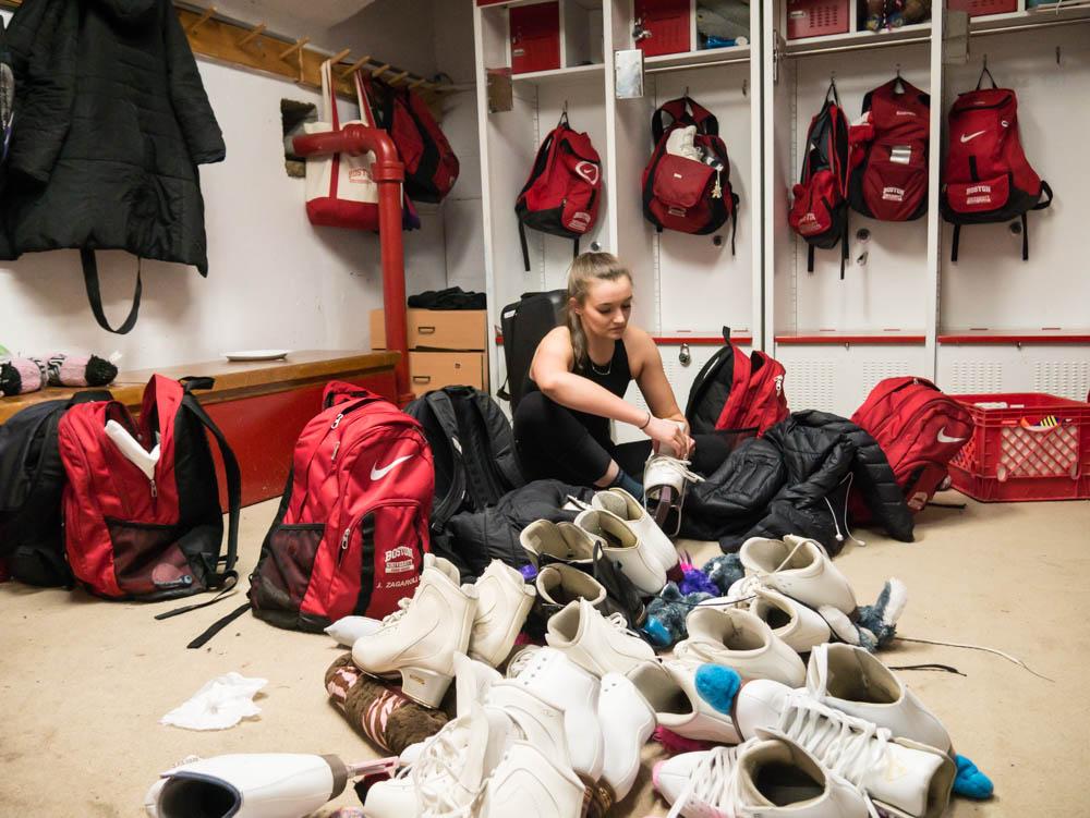Sophomore Isabel Terranova puts on skates in the locker room. The BU figure skating and synchronized skating club teams are raising funds to renovate their locker room. PHOTO BY FELIX PHILLIPS/DAILY FREE PRESS STAFF

