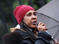 carla sheffield speaks at a mass action against police brutality event