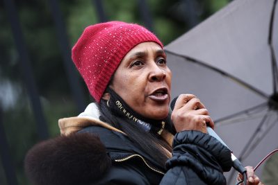 carla sheffield speaks at a mass action against police brutality event