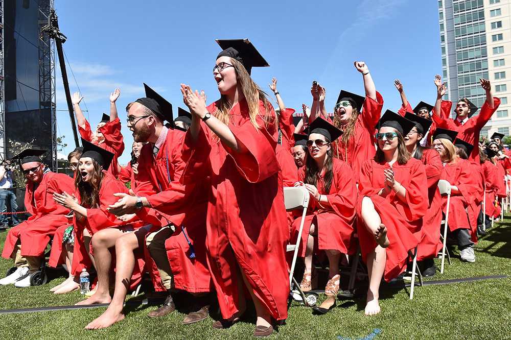 Graduates rise from their seats during Boston University’s All-University Commencement Ceremony. Tickets for a package of Senior Week events this year costs $75. PHOTO BY MADDIE MALHOTRA/DFP FILE PHOTO 

