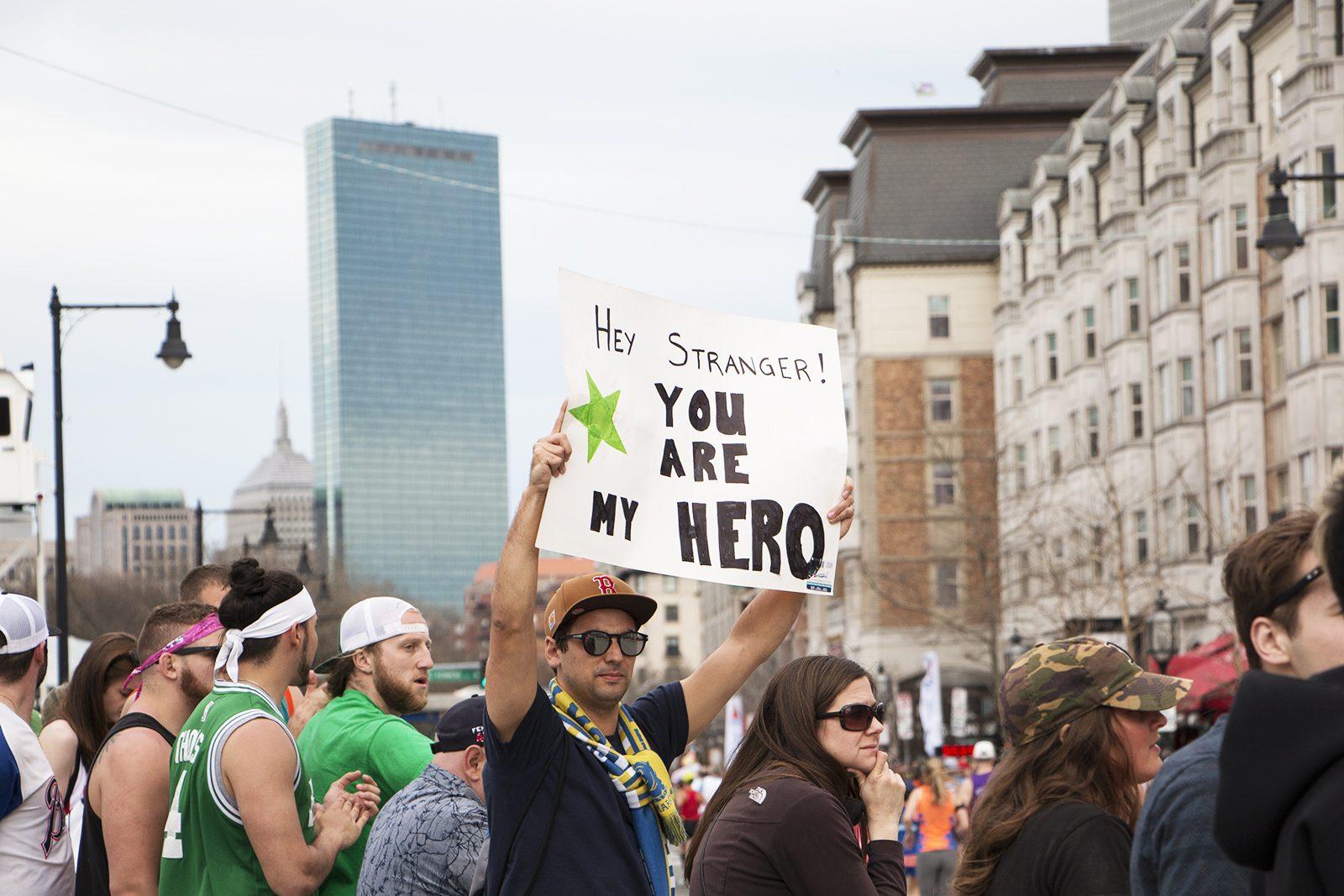 A fan holds up a sign at Kenmore Square to runners passing by. PHOTO BY KELSEY CRONIN/ DAILY FREE PRESS STAFFPHOTO BY KELSEY CRONIN/ DAILY FREE PRESS STAFF