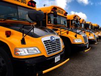 Row of electric school buses in a lot