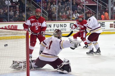 Freshman forward Pat Curry rips a power-play goal top corner on BC's Joseph Woll. PHOTO BY MADDIE MALHOTRA/ DAILY FREE PRESS STAFF 