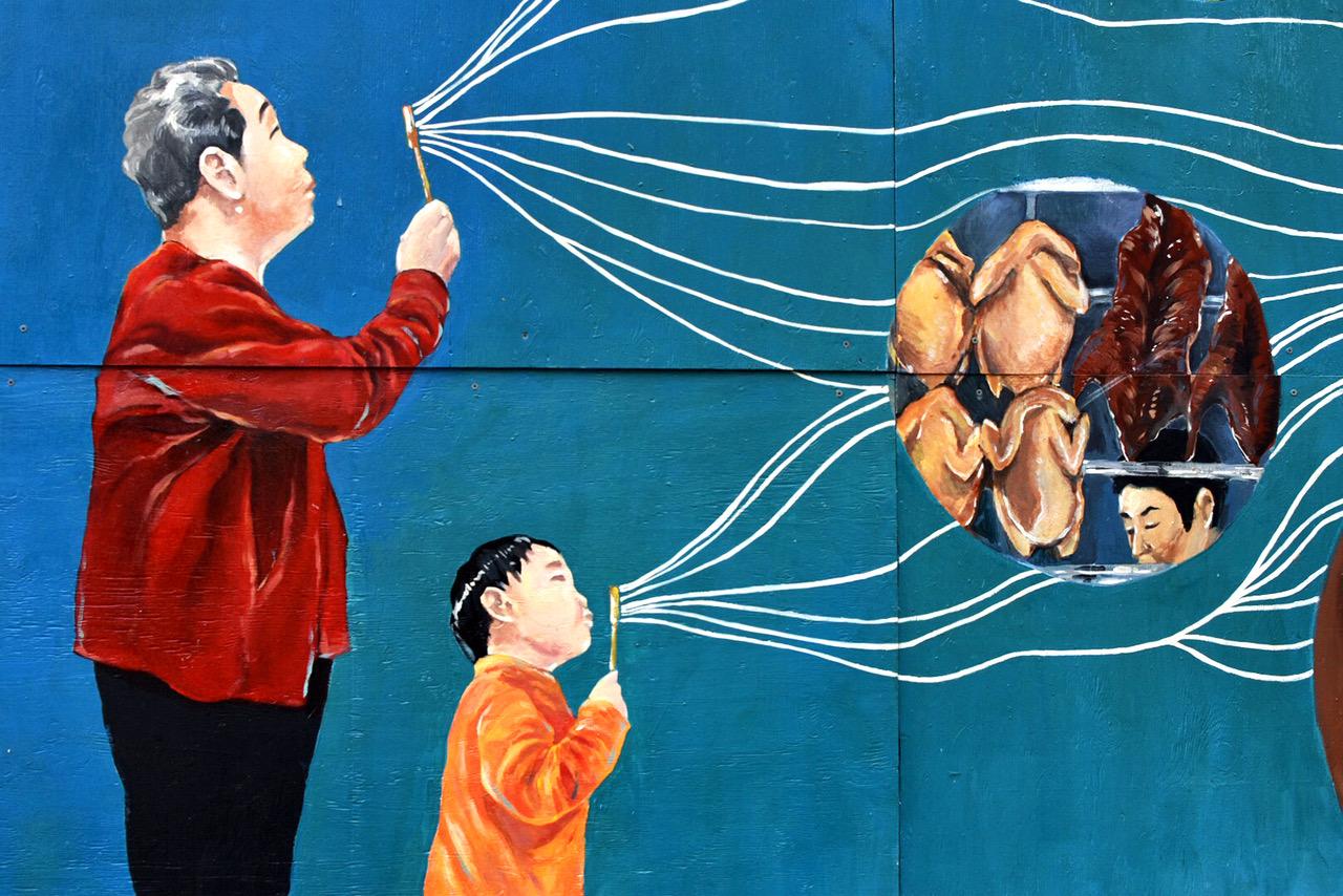Participators of the Clif Bar and Runstreet Boston Art Run ran past this mural in Chinatown on Sept. 21. PHOTO BY VIOLET GIDDINGS/ DAILY FREE PRESS STAFF