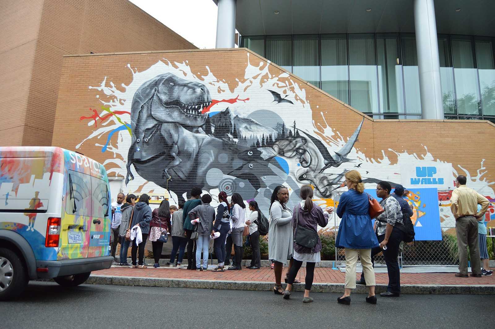 Attendees of a celebration for the New England Foundation of the Arts view the newly unveiled mural by Cedric Douglas in celebration of the new UP Walls program. PHOTO BY ERIN BILLINGS/ DAILY FREE PRESS STAFF