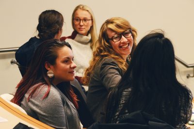 Attendees converse with one another, sharing their reasons for taking part in a salary negotiations seminar hosted by RISE Forum and herNetwork Thursday in the Questrom School of Business. PHOTO BY VIGUNTHAAN THATMARAJAH/ DAILY FREE PRESS STAFF