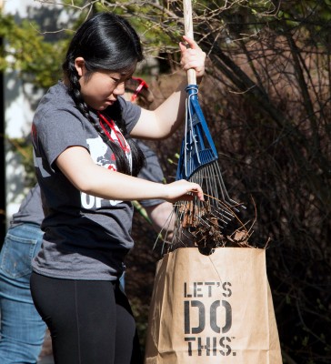 Jan Xi (Questrom '17) rakes leaves in Brookline Saturday for Boston University's Global Days of Service. PHOTO BY OLIVIA NADEL/DAILY FREE PRESS STAFF