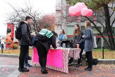 Students outside of the George Sherman Union write cards to women recently elected to office as a demonstration of solidarity with “Pantsuit Nation.” PHOTO BY ABBY FREEMAN/ DAILY FREE PRESS STAFF