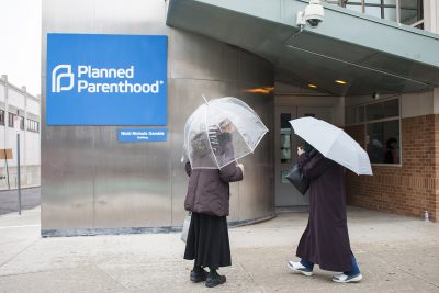 Two protesters stand outside of the Planned Parenthood Greater Boston Health Center on Commonwealth Avenue. PHOTO BY KANKANIT WIRIYASAJJA/ DAILY FREE PRESS STAFF