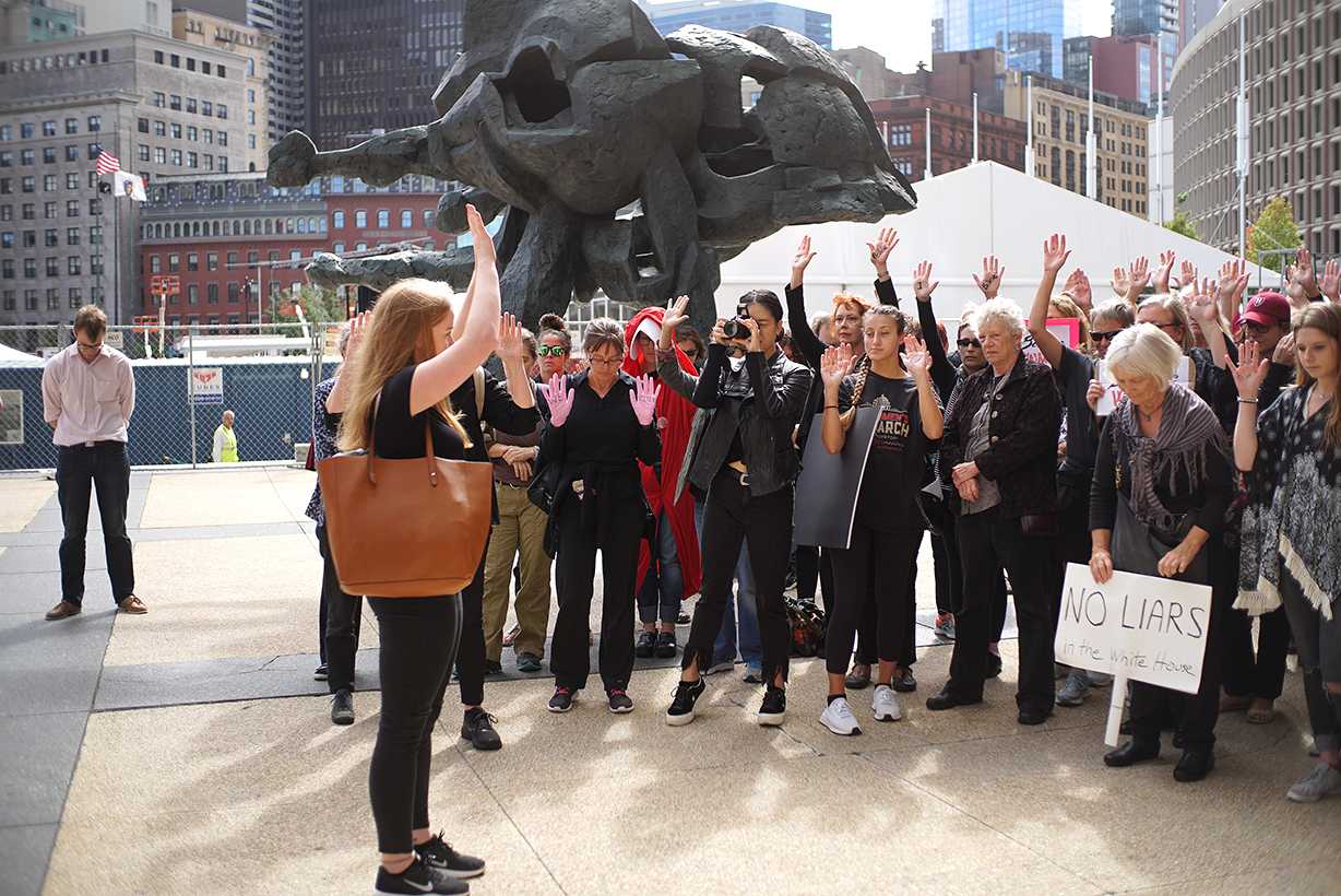 Boston University sophomore Sarah Horn leads a protest Thursday afternoon in front of the John F. Kennedy Federal Building. The speakout was organized as a show of solidarity with Christine Blasey Ford, who has accused United States Supreme Court nominee Brett Kavanaugh of sexually assaulting her. SOPHIE PARK/ DAILY FREE PRESS STAFF