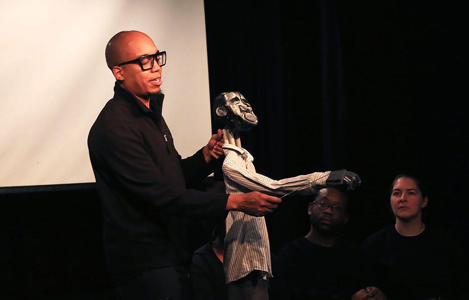 Puppeteer Tarish "Jeghetto" Pipkins performs in “Just Another Lynching: An American Horror Story” Friday night. ZIJING FU/ DAILY FREE PRESS STAFF