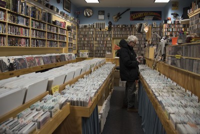A customer shops for used CDs at Planet Records near Harvard Square. PHOTO BY LEXI PLINE/DAILY FREE PRESS STAFF