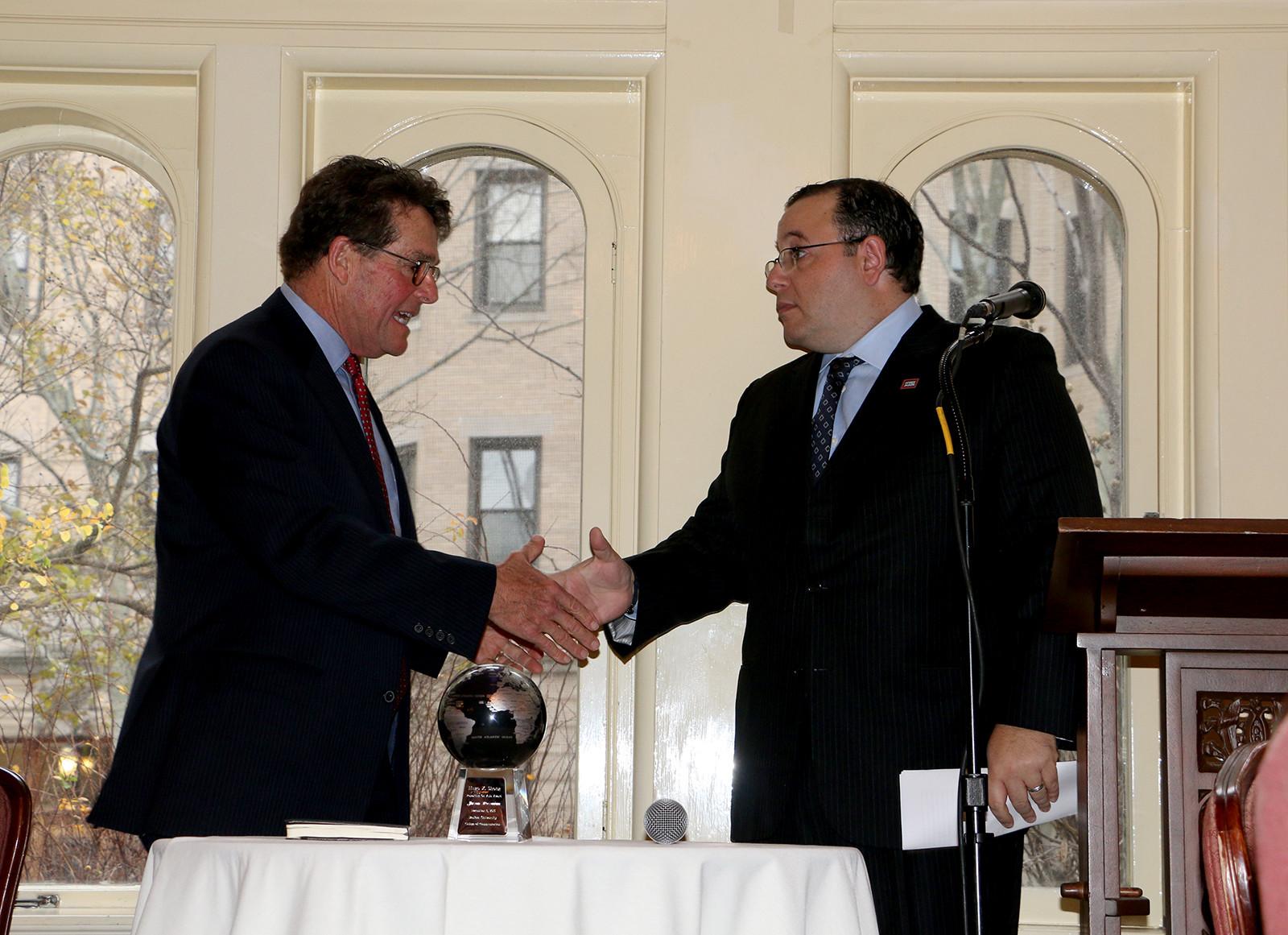 Boston University College of Communication Dean Thomas Fiedler presents the Hugo Shong Reporting on Asia Award to Ali Rezaian, who is accepting the award on behalf of his brother Jason Rezaian. PHOTO BY KELSEY CRONIN/DAILY FREE PRESS STAFF