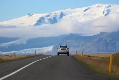 car driving on a road near mountains