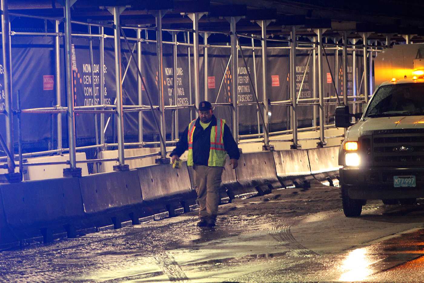 man walks through flooding at boston university