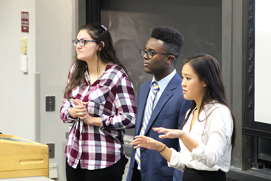 From left to right: College of Arts and Sciences Student Government Senators Savannah Majarwitz, Amos Mwuara and Jessica Zheng present a proposal to amend a bylaw of the Senate Outreach Program. RACHEL SHARPLES/ DAILY FREE PRESS STAFF