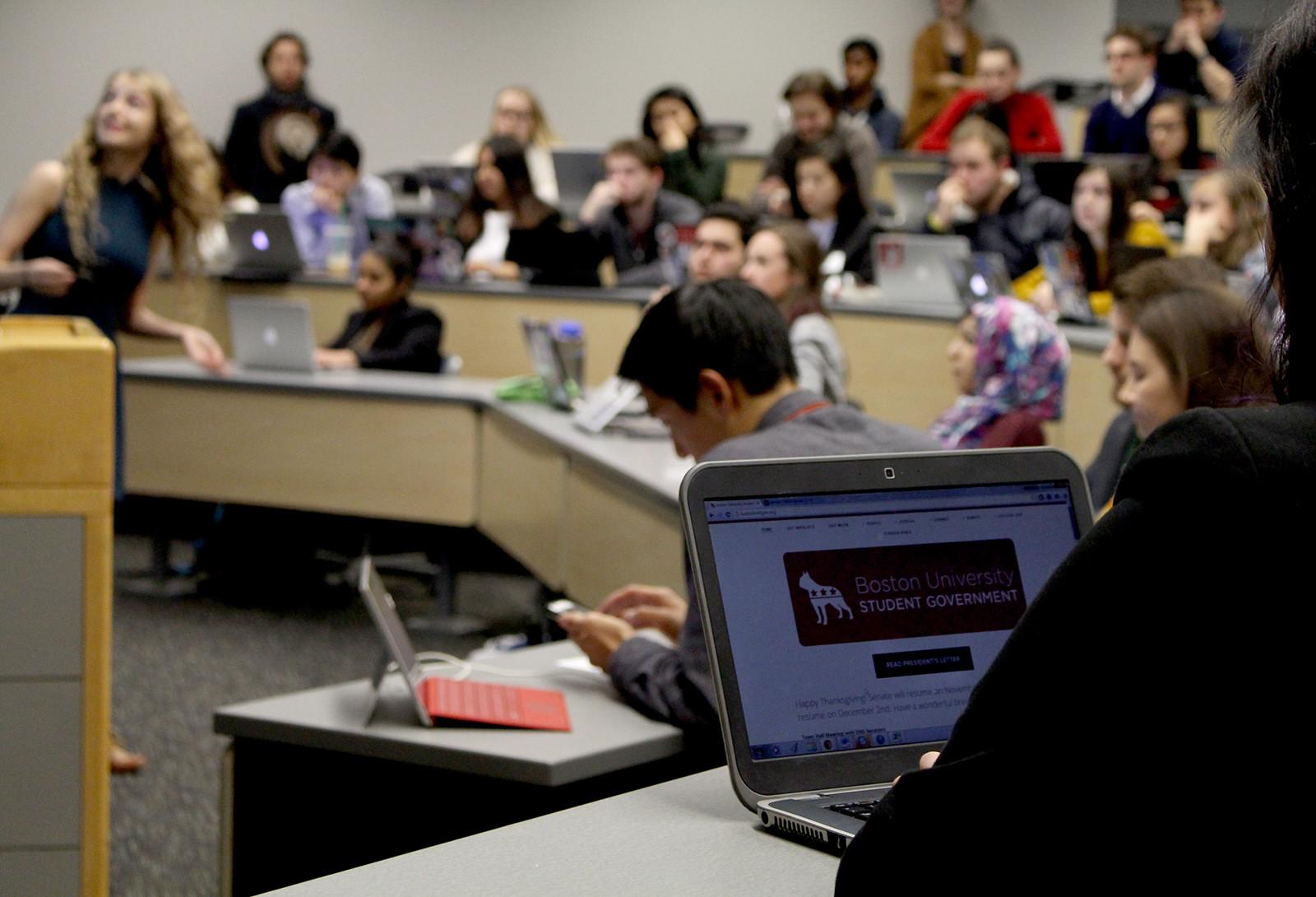 A Boston University Student Government member reviews the meeting's agenda Monday night. PHOTO BY BRIGID KING/DAILY FREE PRESS STAFF
