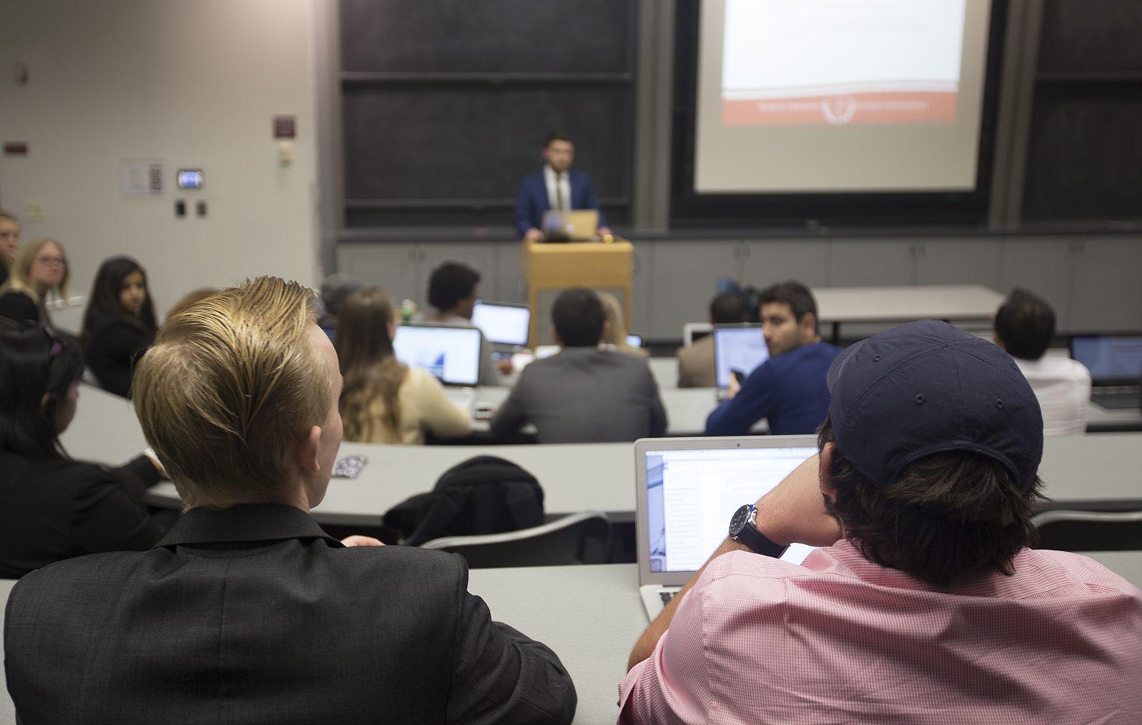 Judicial commissioner Brian Butler (left) listens while SG Senate Chair Daniel Collins addresses the Boston University Student Government Monday night in the Photonics Center. PHOTO BY KANKANIT WIRIYASAJJA/ DAILY FREE PRESS STAFF 