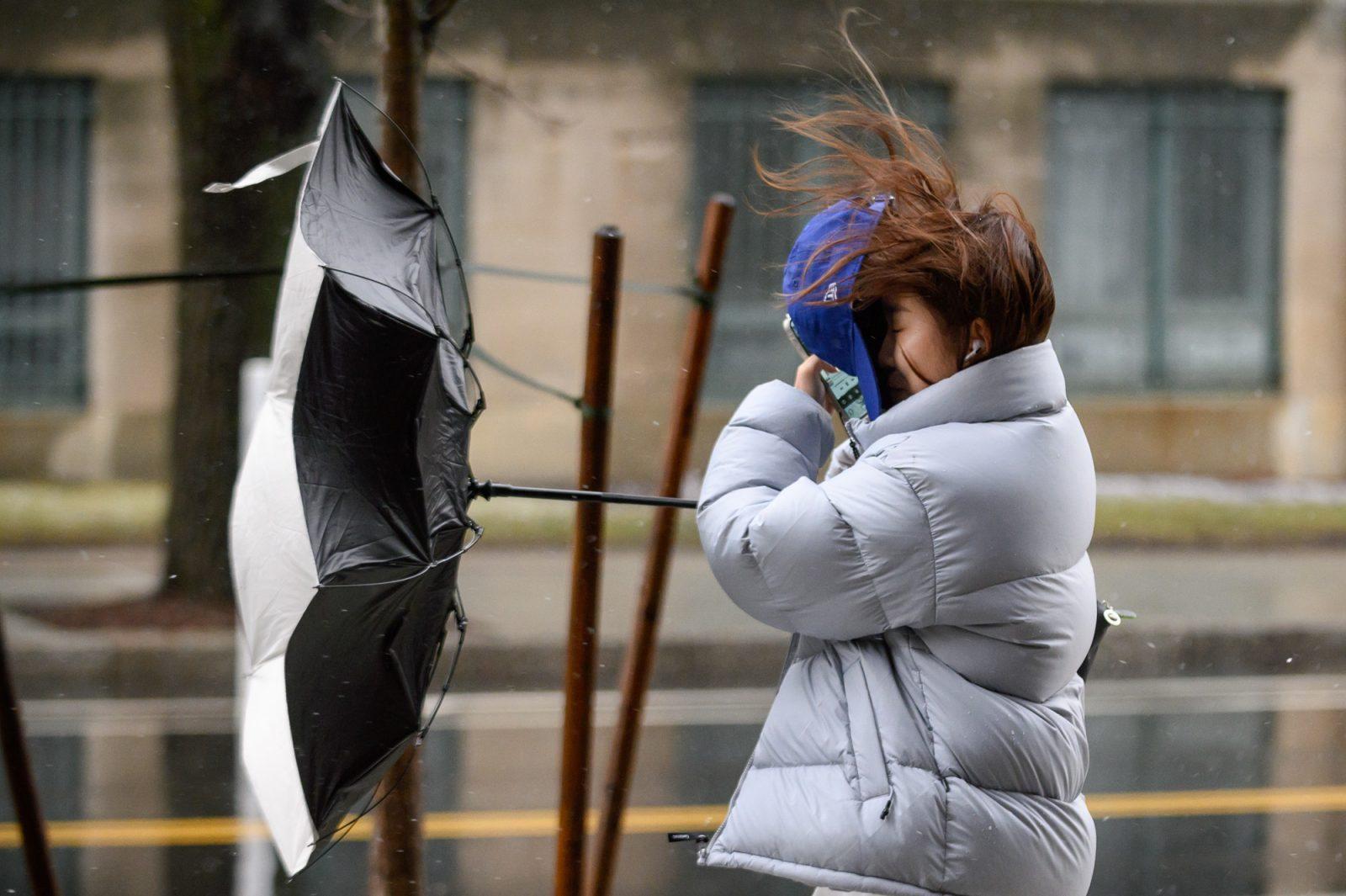 Raine Wang, a College of Arts and Science sophomore, catches her hat as the wind knocks it off her head and her umbrella inverts. Boston University’s Charles River, Fenway and Medical Campuses closed for a snow day on Tuesday after Mayor Wu declared a snow emergency, causing public schools and universities in the Boston area to close. ANDREW BURKE-STEVENSON/DFP PHOTOGRAPHER
