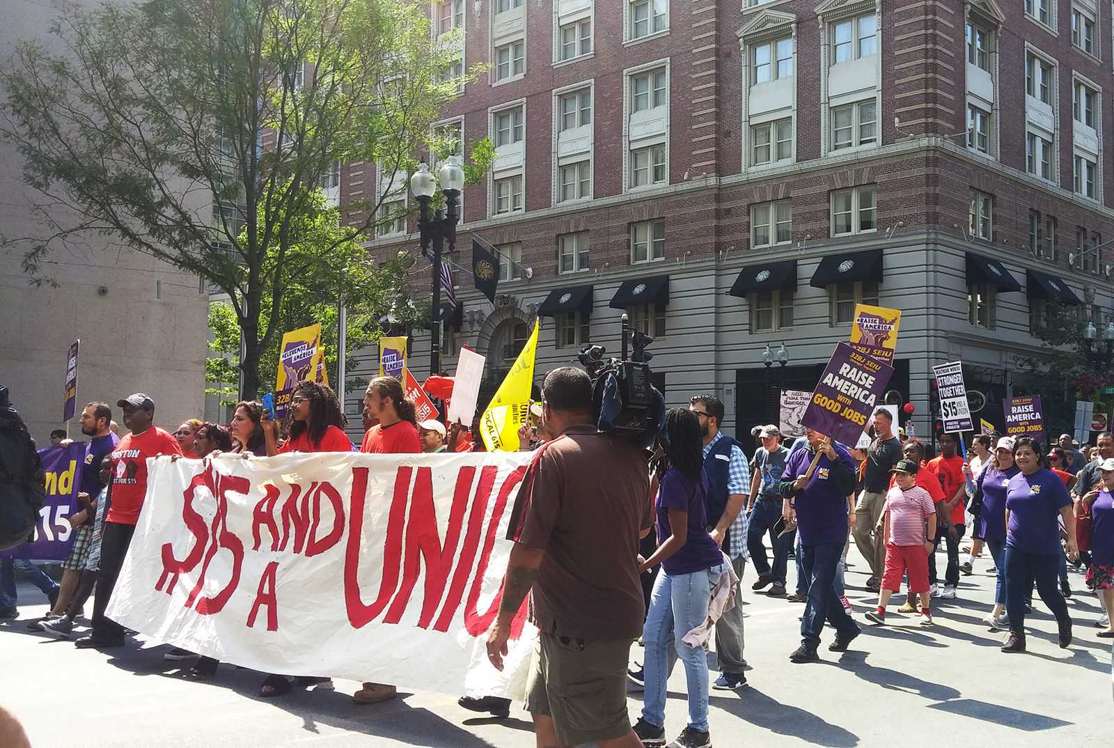 Bostonians march on Boylston Street during the Labor Day Rally Tuesday afternoon. PHOTO BY SOPHIA BROWN/ DAILY FREE PRESS STAFF