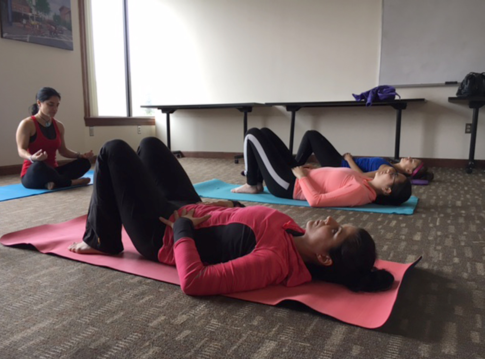 Three women participate in a free yoga class during a SPARK Boston pop-up event. PHOTO BY ANDRES PICON/ DAILY FRESS STAFF