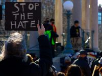 demonstrator holds a stop the hate sign at a stop asian hate rally in boston common