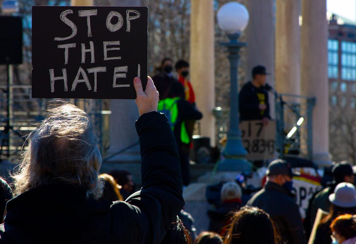 demonstrator holds a stop the hate sign at a stop asian hate rally in boston common