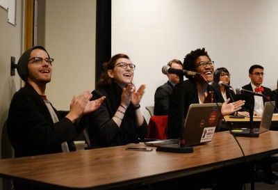 At the 2016 Student Government Election Slate Debate on Thursday, Clean Slate Presidential candidate and junior in the College of Arts and Sciences Jake Brewer; VP of Finance candidate and CAS sophomore Hanaan Yazdi; and VP of IA candidate and CAS sophomore Jane Dimnwaobi react to the arrival of Sara Ann Kurkul, their VP candidate and a sophomore in the College of General Studies. PHOTO BY SAVANAH MACDONALD/DAILY FREE PRESS STAFF