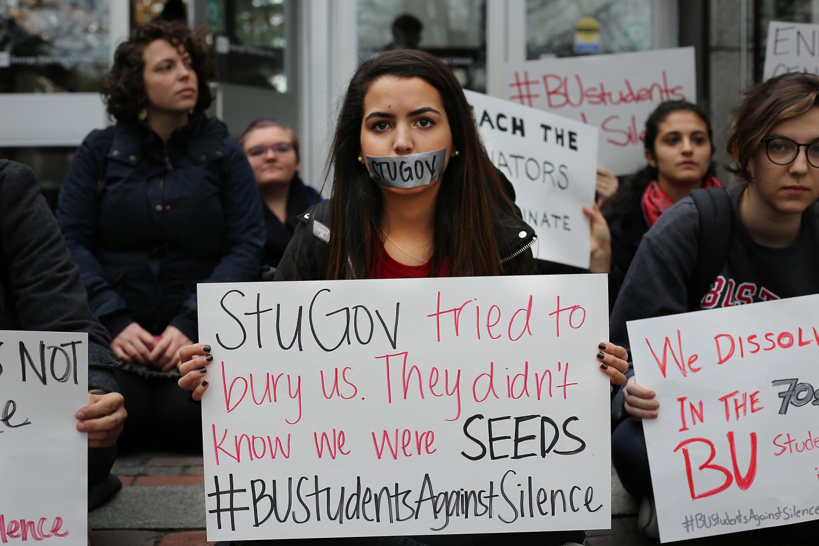 A protester holds a sign during a #BUStudentsAgainstSilence protest outside the George Sherman Union Tuesday afternoon. PHOTO BY EMILY ZABOSKI/DAILY FREE PRESS STAFF