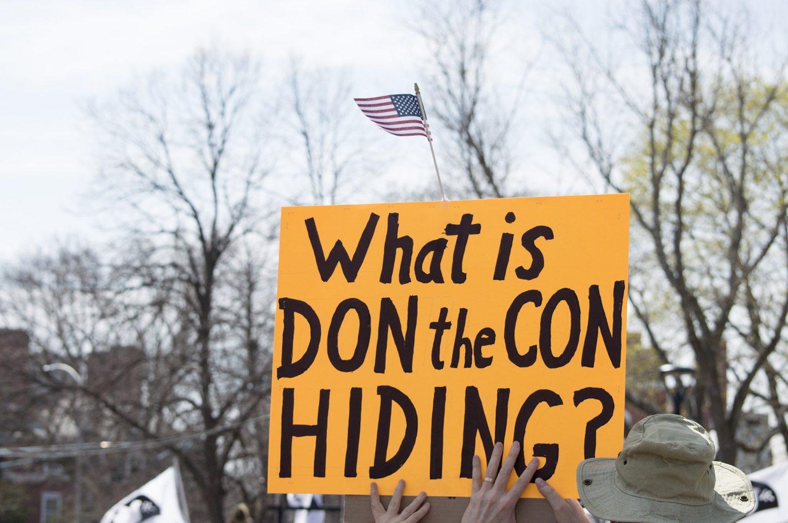 Locals gather at Cambridge Common Saturday afternoon to protest President Donald Trump’s refusal to release his tax returns. PHOTO BY VIGUNTHAAN THARMARAJAH/ DAILY FREE PRESS STAFF