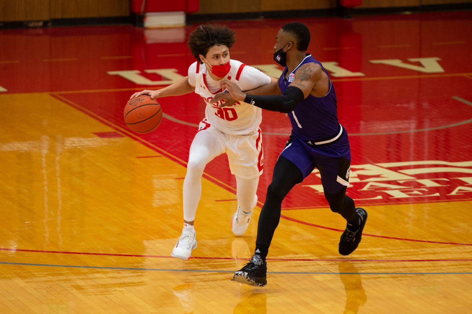 Boston University senior Javante McCoy in a Tuesday game against the College of the Holy Cross. BU men’s and women’s basketball players wore masks in their opening series against Holy Cross and must do so for the rest of the season. COURTESY OF MATT WOOLVERTON VIA BU ATHLETICS