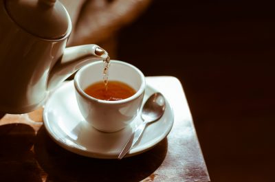 teapot pours tea into a teacup