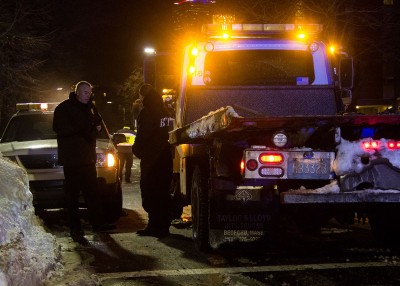 Boston police prepare to tow cars from Bay State Road Tuesday night. PHOTO BY ALEXANDRA WIMLEY/DAILY FREE PRESS STAFF