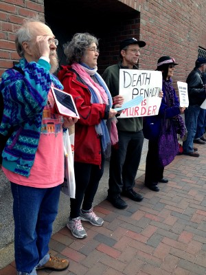 (From left) Devon McCullough, 60, of Arlington, Amy Hendrickson, 71, of Brookline, Joe Kebartas, 66, of South Boston and Carolyn Whiting, 65, of Reading, protest the death penalty Monday in front of the John Joseph Moakley United States Courthouse. PHOTO BY FELICIA GANS/DAILY FREE PRESS STAFF