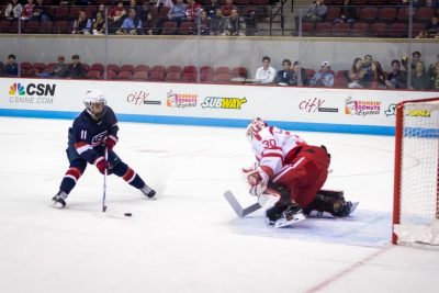 Terrier goaltender Connor LaCouvee (30) defends against USA forward Jacob Tortora (11) on one of the few USA scoring attempts during the game between the Boston University Terriers and the USA Hockey's U-18 Development Team at Agganis Arena in Boston, MA. (Photo by John Kavouris/Daily Free Press)