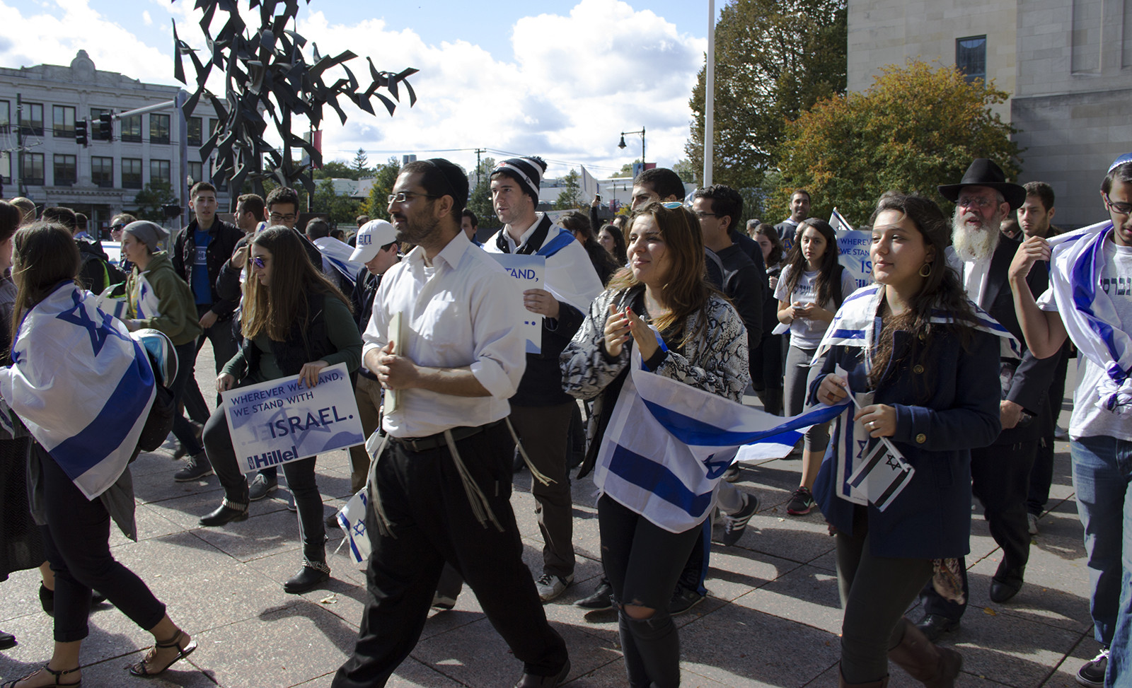 Rabbi YD Schwartz (left) leads Boston University Students for Israel in a "Vigil for Victims of Terrorism" at Marsh Plaza Friday. PHOTO BY MARY SCHLICHTE/DAILY FREE PRESS STAFF