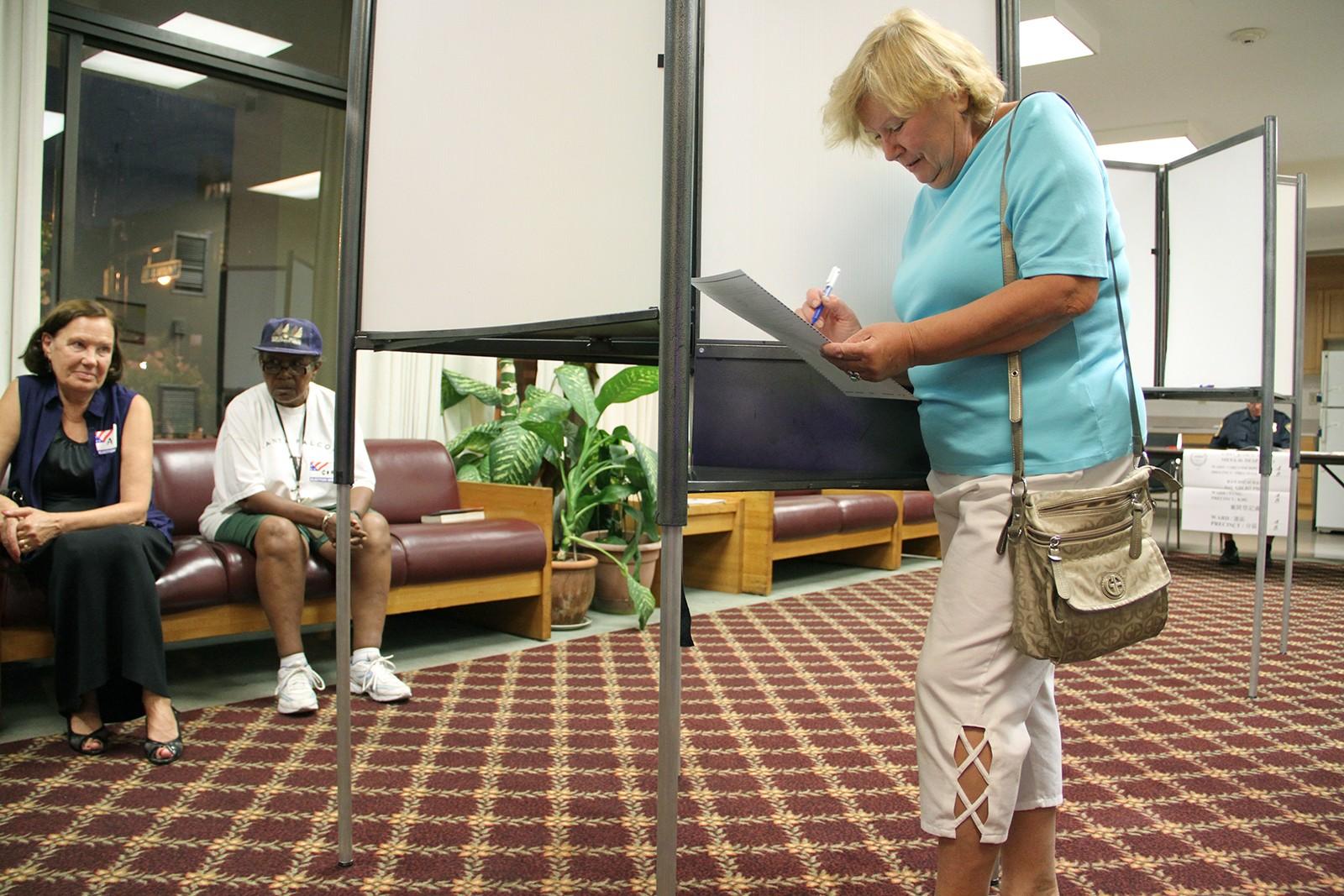 Severo Olga places her vote Tuesday for city council at a polling place at 333 Massachusetts Ave. PHOTO BY SARAH SILBIGER/DAILY FREE PRESS STAFF