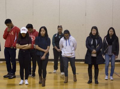 During a privilege walk Tuesday night in the SAC Gym, students stand along the baseline in the gym, close their eyes and step forward when certain aspects of privilege apply to them. PHOTO BY NATALIE CARROLL/ DAILY FREE PRESS STAFF