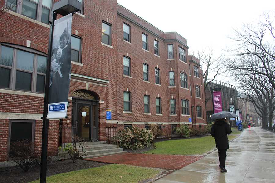 A student walks by a dorm on Wheelock's campus. April 1 was the deadline by which Wheelock students had to commit to transitioning to BU. PHOTO BY HANNAH ROGERS/DAILY FREE PRESS STAFF
