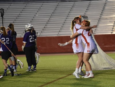 Senior attack Mallory Collins embraces sophomore attack Mickenzie Larivee following a goal in the Terriers’ 11-4 victory over Holy Cross, which helped them secure a postseason birth. PHOTO BY MADDIE MALHOTRA/DAILY FREE PRESS STAFF