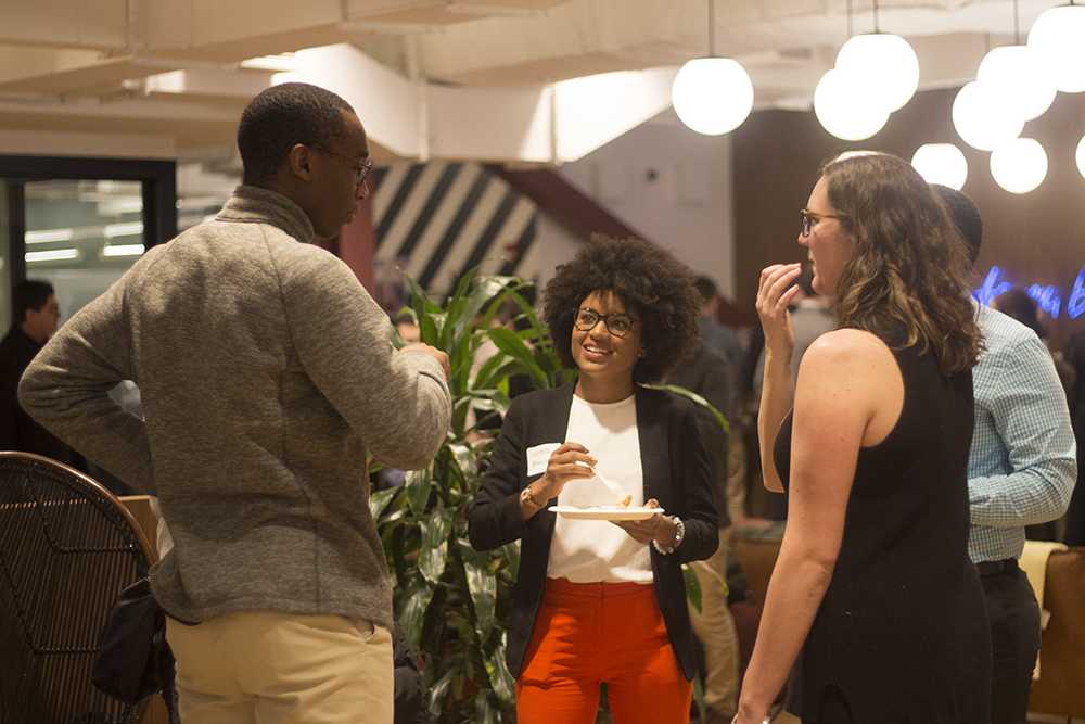 People mingle at a Startup Institute and Hack Diversity sponsored event in Boston on Thursday evening. PHOTO BY MALAIKA MOYER/ DAILY FREE PRESS STAFF

